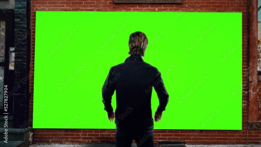 Man Looks Street Panel Outdoor Green Screen. Man standing in front of a