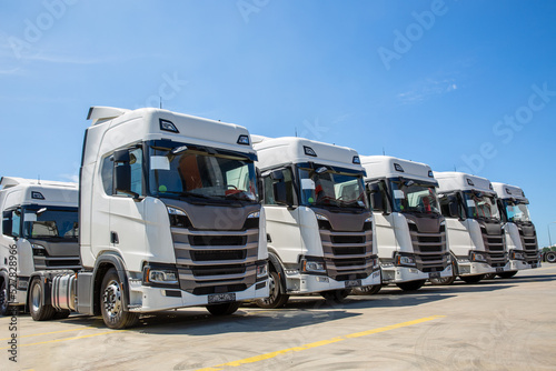 New heavy trucks in truck store, trucks lined up photo