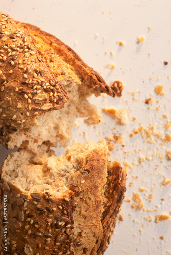 Fototapeta premium Bitten and cut bread with crumbs around