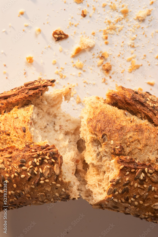 Fototapeta premium Bitten and cut bread with crumbs around