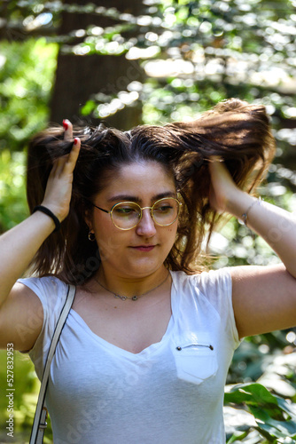 Young woman combing her hair with her hands