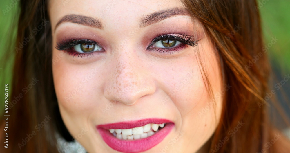 Pretty hispanic young woman face opening eyes looking to camera smiling Pretty hispanic young woman face opening eyes looking to camera smiling