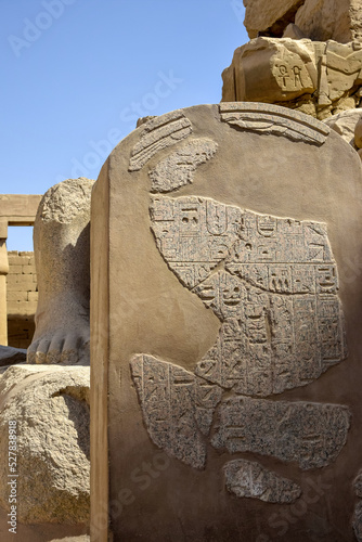 Part of wall with ancient Egyptian hieroglyphs and symbols in Karnak Temple complex (ancient Thebes). Luxor, Egypt. Copy space. Selective focus. photo