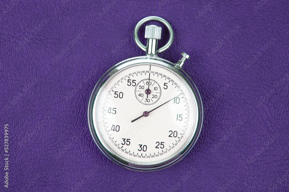 mechanical analog stopwatch on a colored background. Time part precision. Measurement of the speed interval