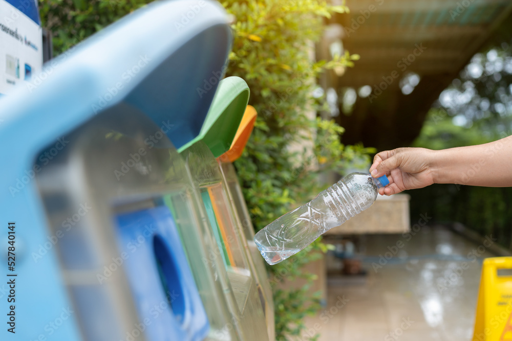 woman hand picking up plastic bottle for cleaning at park
woman hand picking up plastic bottle for cleaning at park
