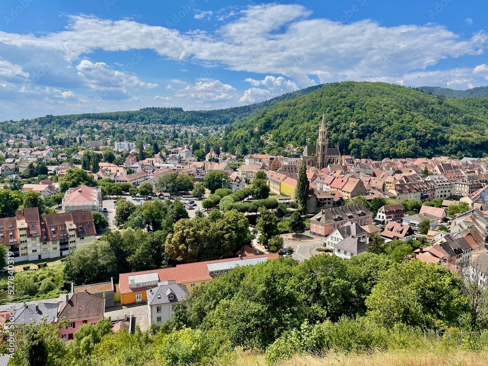 Aerial view over the rooftops of the city of Thann in Alsace on a sunny summer day