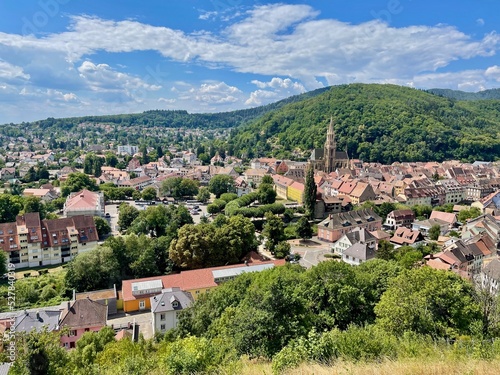 Aerial view over the rooftops of the city of Thann in Alsace on a sunny summer day