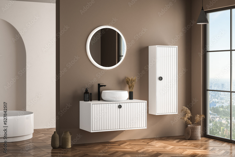 Modern bathroom interior with beige walls, white basin with oval mirror ...