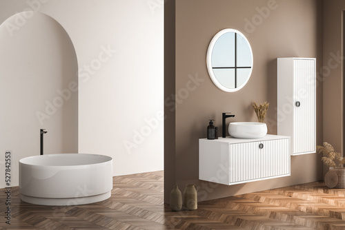 Modern bathroom interior with beige walls  white basin with oval mirror  bathtub and parquet floor. Minimalist beige bathroom with modern furniture. 3D rendering