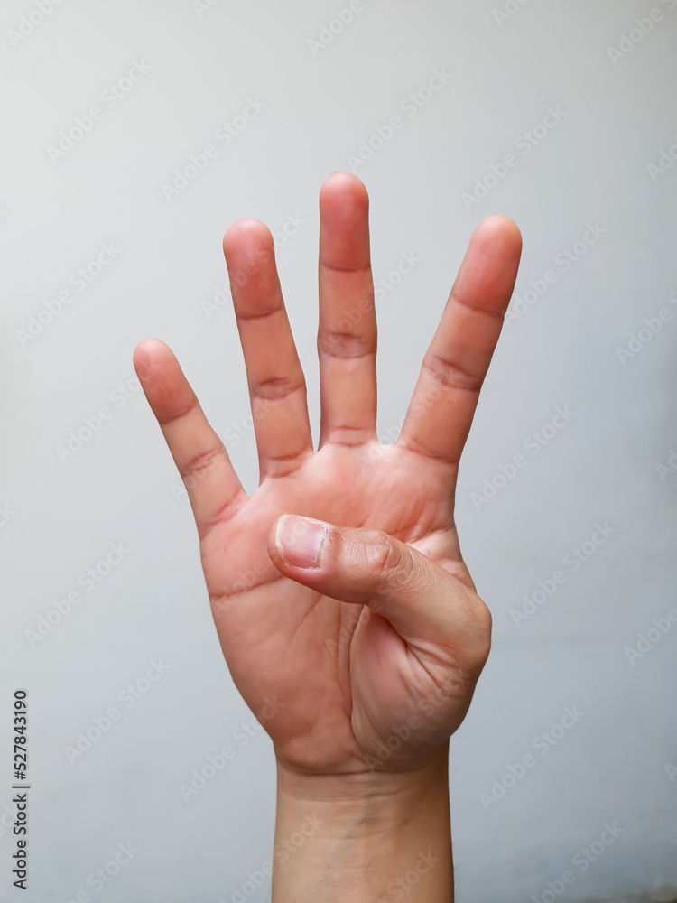 Naklejka premium hand with four finger gesture on a white background
