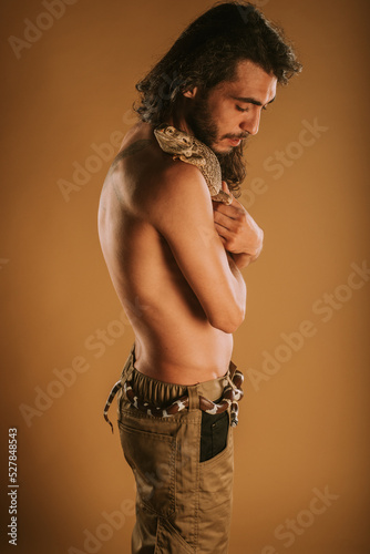 Man posing with bearded dragon and California kng snake photo