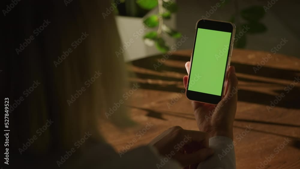 Handheld close up woman holding smart phone with green screen chroma ...