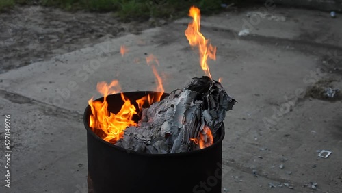 Dumpster Fire Large Orange Flames Lick Out of Trashcan Fire photo