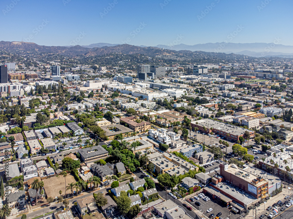 Hollywood, California, USA – August 30, 2022: Aerial Drone View around Sunset Blvd and Highland Ave with Hollywood Walk of Fame, Hollywood Blvd, and the Mountain with Hollywood Sign