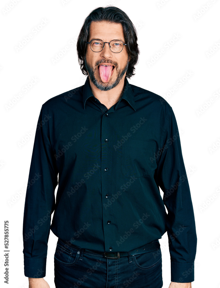 Middle age caucasian man wearing casual clothes and glasses sticking tongue out happy with funny expression. emotion concept. Middle age caucasian man wearing casual clothes and glasses sticking tongue out happy with funny expression. emotion concept.