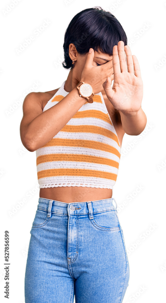 Young brunette woman with short hair wearing casual clothes covering eyes with hands and doing stop gesture with sad and fear expression. embarrassed and negative concept. Young brunette woman with short hair wearing casual clothes covering eyes with hands and doing stop gesture with sad and fear expression. embarrassed and negative concept.