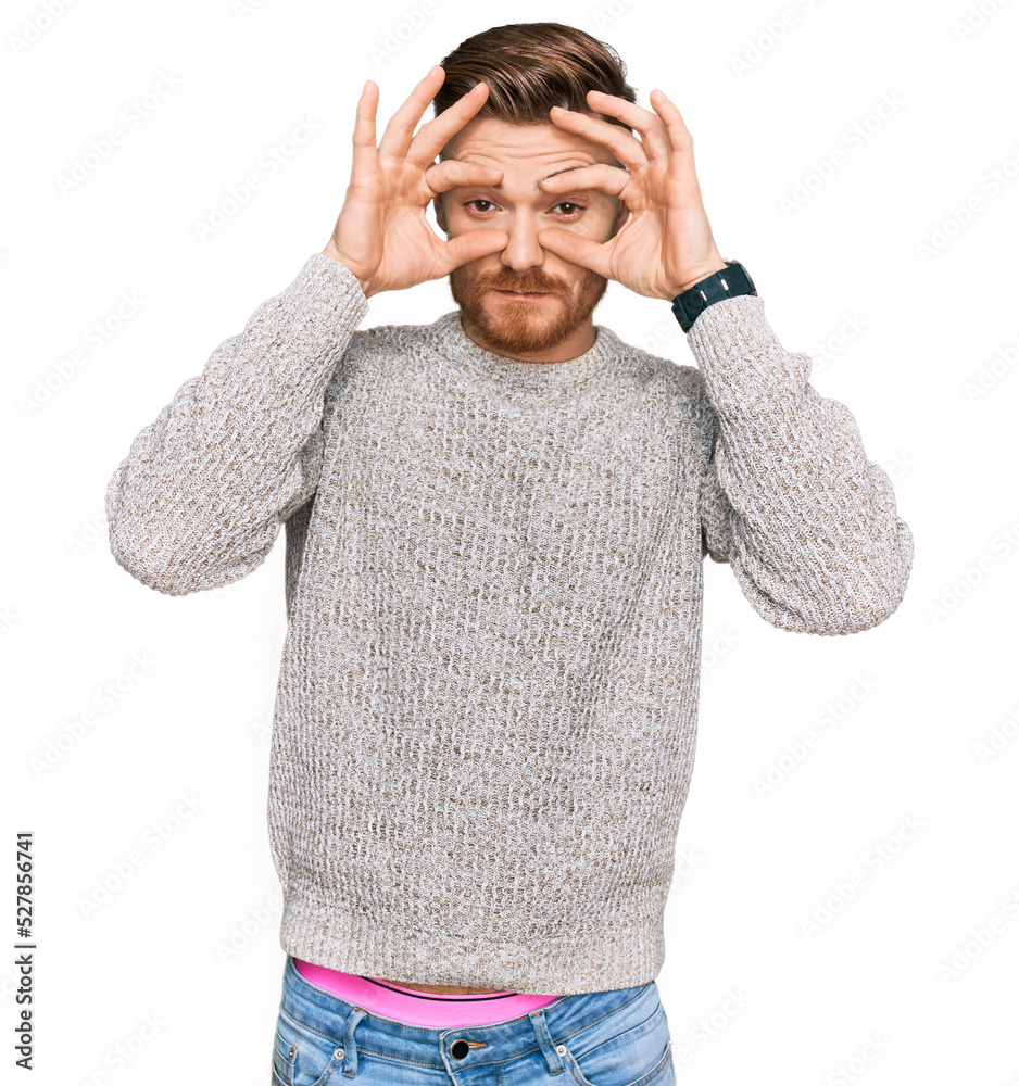 Naklejka premium Young redhead man wearing casual winter sweater trying to open eyes with fingers, sleepy and tired for morning fatigue