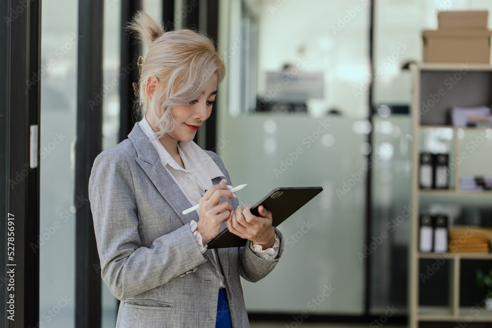 Portrait of a beautiful asian businesswoman holding a financial market data standing at office. Portrait of a beautiful asian businesswoman holding a financial market data standing at office.