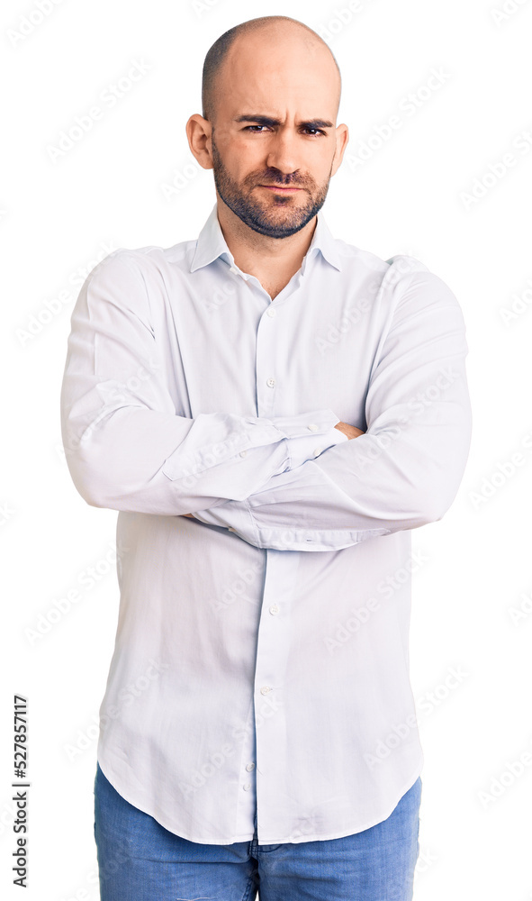 Young handsome man wearing elegant shirt skeptic and nervous, disapproving expression on face with crossed arms. negative person. Young handsome man wearing elegant shirt skeptic and nervous, disapproving expression on face with crossed arms. negative person.