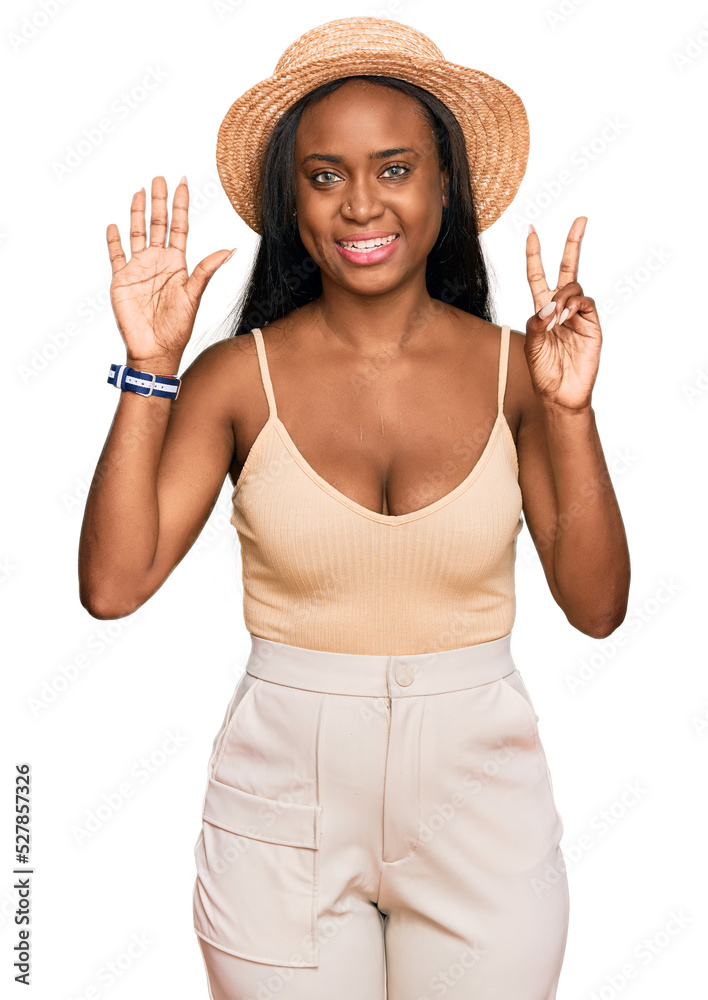 Young black woman wearing summer hat showing and pointing up with fingers number seven while smiling confident and happy. Young black woman wearing summer hat showing and pointing up with fingers number seven while smiling confident and happy.