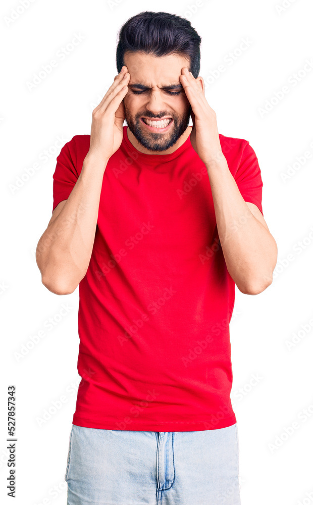 Fototapeta premium Young handsome man with beard wearing casual t-shirt with hand on head for pain in head because stress. suffering migraine.