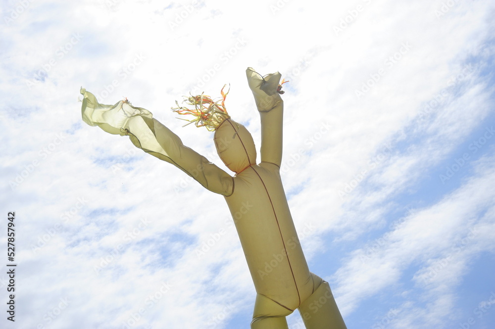 Rubber man flying high in the clouds outside. Rubber man flying high in the clouds outside.