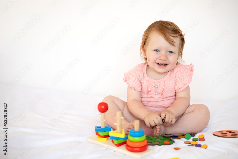 Emotional cute Baby is playing. Infant learning and development. Wooden eco-friendly educational toys. Montessori system. Emotional cute Baby is playing. Infant learning and development. Wooden eco-friendly educational toys. Montessori system.