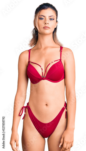 Young beautiful woman wearing bikini looking sleepy and tired, exhausted for fatigue and hangover, lazy eyes in the morning. © Krakenimages.com