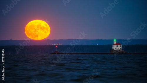 Moonrise behind Superior Entry Lighthouse on Lake Superior. 