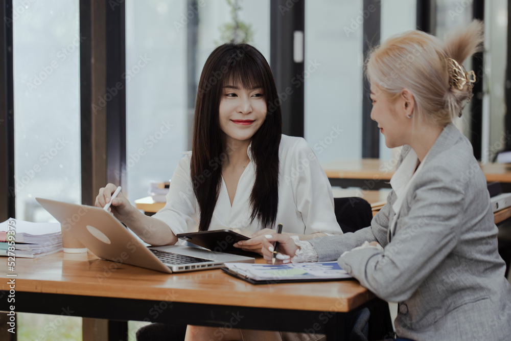 Fototapeta premium Technology and financial advisory services concert. Business teamwork and working on digital laptop computer with advisor showing plan of investment to clients at table office. Digital marketing.