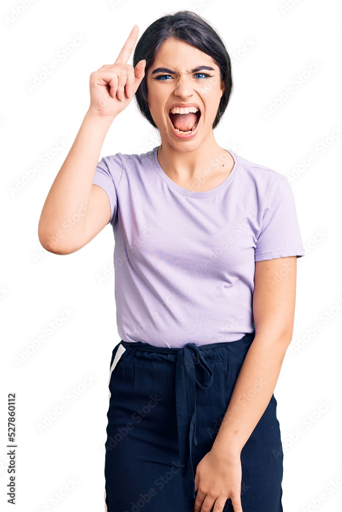 Brunette teenager girl wearing casual clothes pointing finger up with successful idea. exited and happy. number one. Brunette teenager girl wearing casual clothes pointing finger up with successful idea. exited and happy. number one.