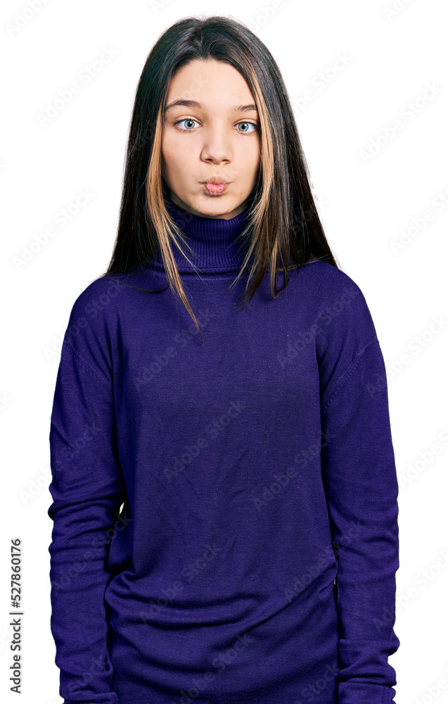 Young brunette girl with long hair wearing turtleneck sweater making fish face with lips, crazy and comical gesture. funny expression. Young brunette girl with long hair wearing turtleneck sweater making fish face with lips, crazy and comical gesture. funny expression.