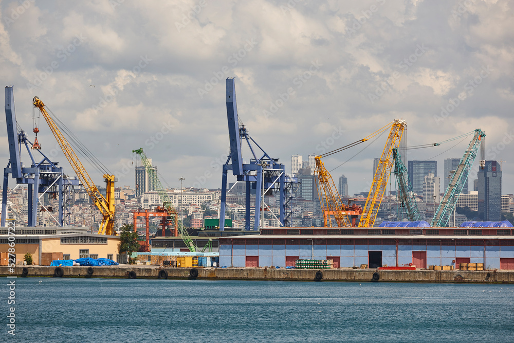 Cranes at comercial seaport. Bosphorus strait in Istanbul. Transportation Turkey