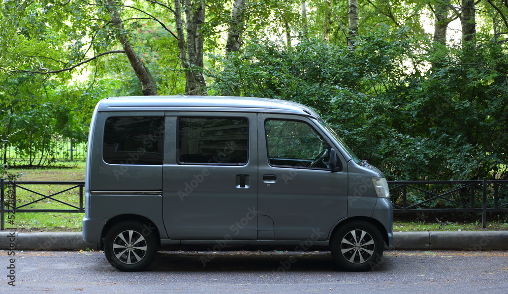 A new gray minivan is parked at the Green Park, Iskrovsky Prospekt, St. Petersburg, Russia, September 2022