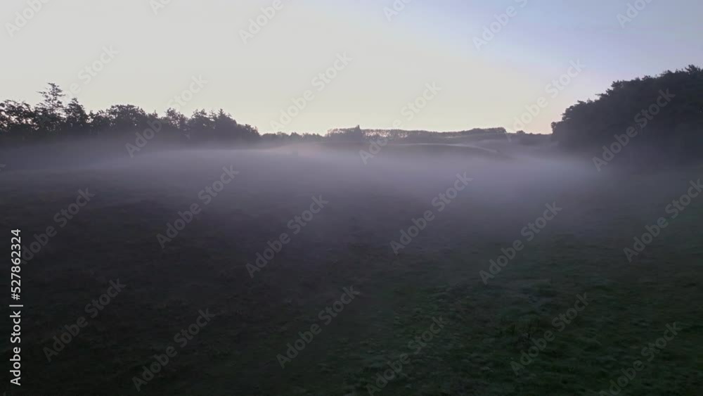 Early morning mist over epic landscape with soft hills seen from drone. Early morning mist over epic landscape with soft hills seen from drone.