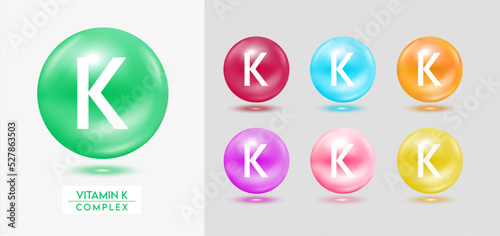 Vitamin K complex. Set of colorful balls multivitamins capsules minerals isolated on grey background. Dietary supplement for pharmacy advertisement, package design. Vector EPS10.