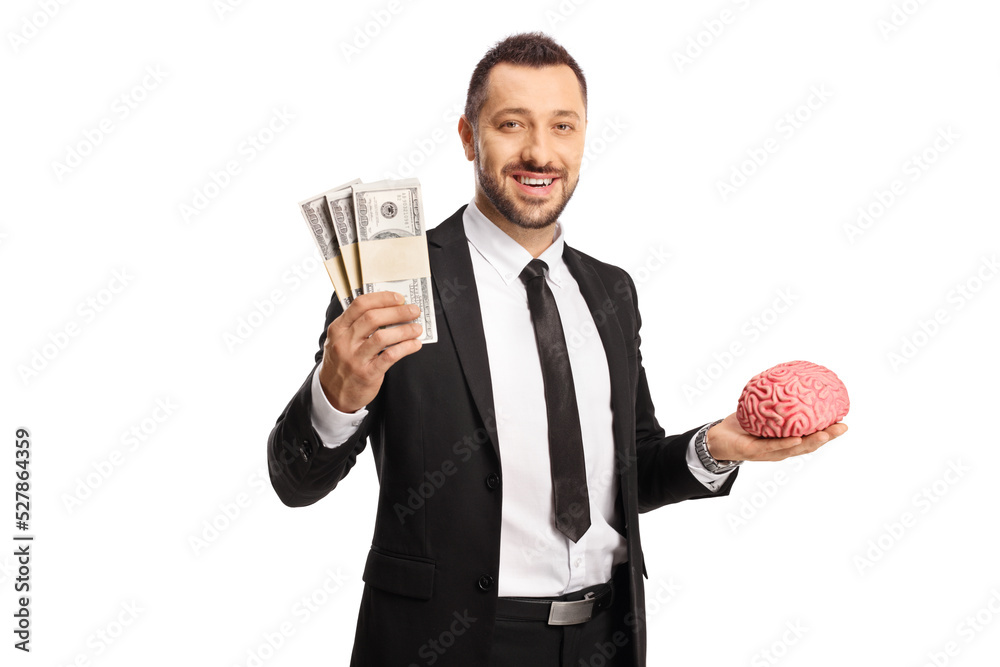 Businessman holding a brain and stacks of money Businessman holding a brain and stacks of money