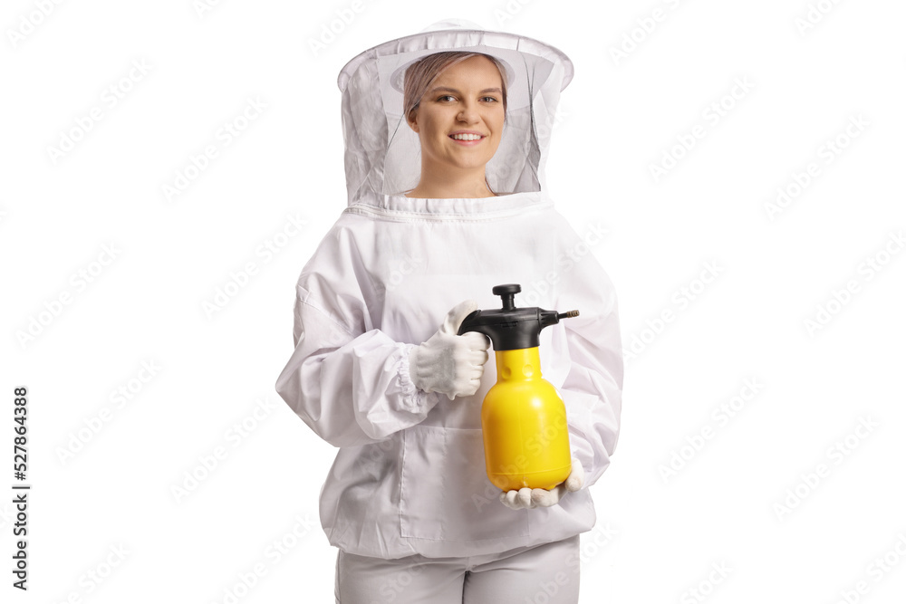 Young female bee keeper in a uniform holding a bottle for spraying Young female bee keeper in a uniform holding a bottle for spraying