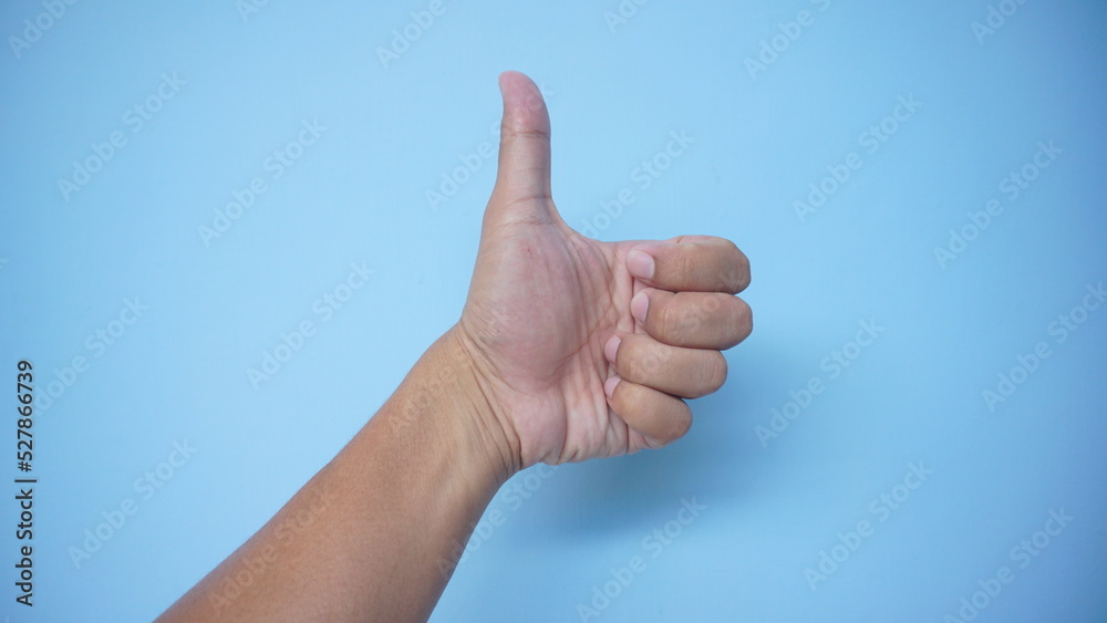 beautiful female hand demonstrates the symbol OK okay with blue background beautiful female hand demonstrates the symbol OK okay with blue background