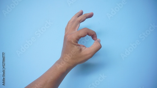 hand ok sign on blue background