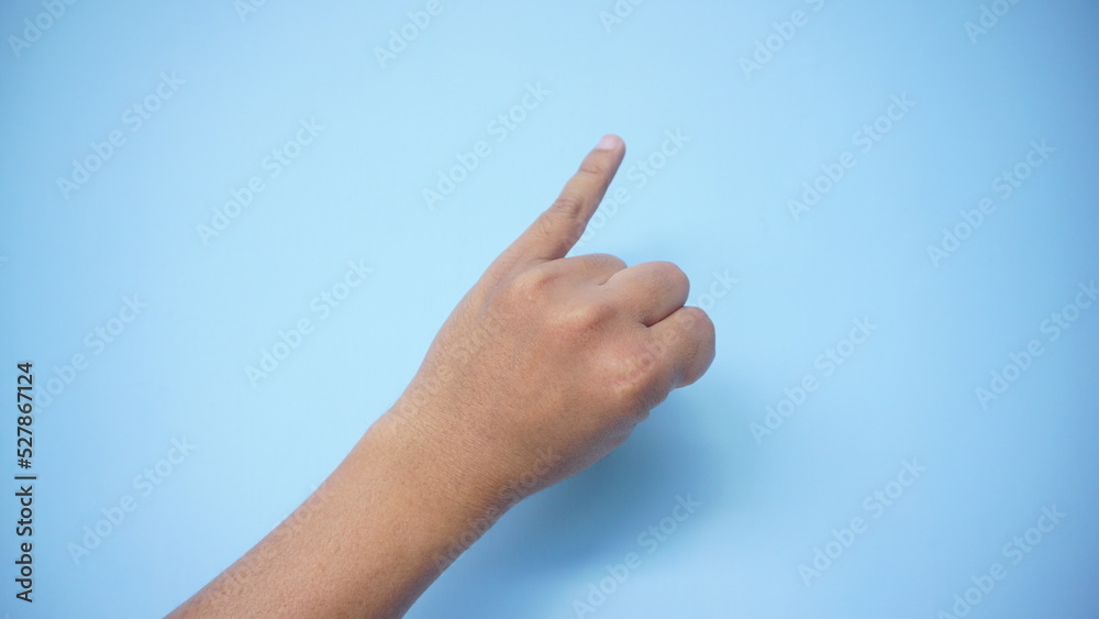 American sign language. Female hand showing letter I isolated on blue background.