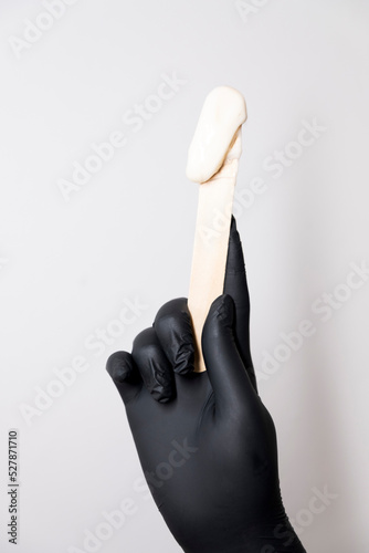 Sugar depilation. A piece of sugar paste dripping from a wooden spatula