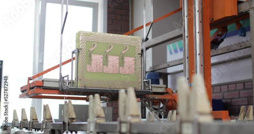 Process of immersion diving of microchips circuit boards in solution in production on factory using automatic equipment. Manufactoring of electronic microcircuits and chips. High-tech technologies.