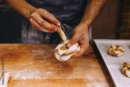 Male baker cooking cinnamon rolls