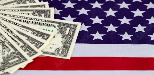 US dollar bills on a flag. Inflation, finance or money savings banner.