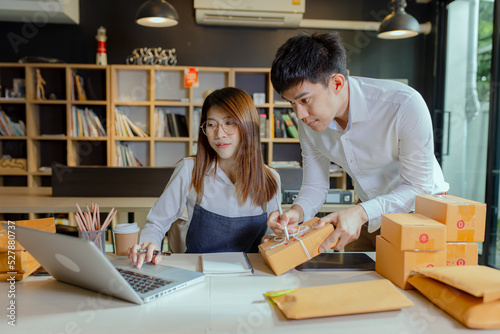 Businesswoman and man working with packaging box at home office, Business online influencer on social media concept, Online Selling, Online Shopping to market, morning sunlight.
