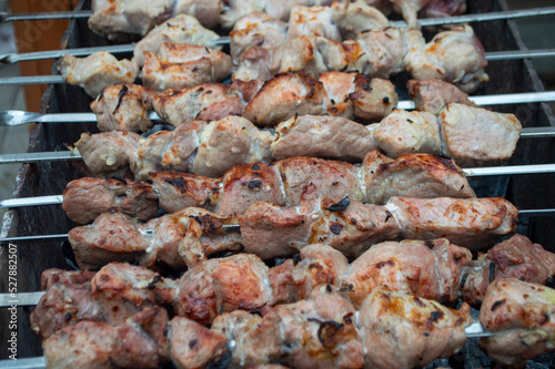 fresh pieces of meat are fried on skewers