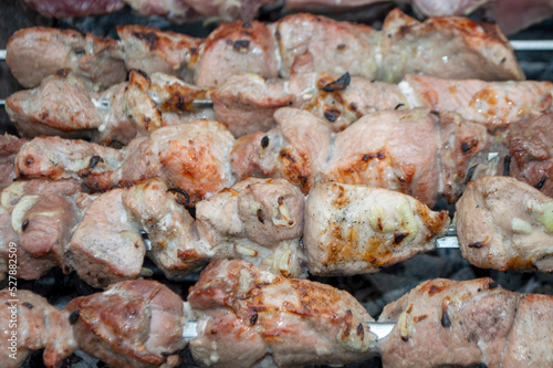 fresh pieces of meat are fried on skewers