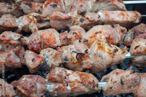 fresh pieces of meat are fried on skewers