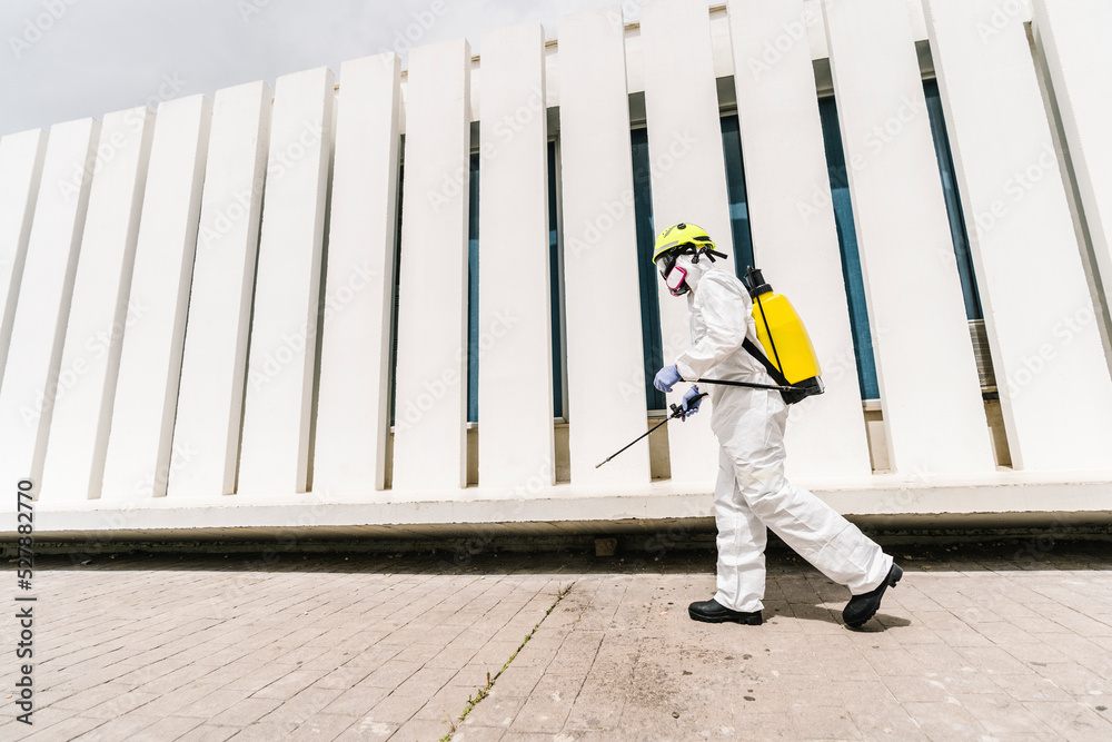 Firefighter disinfecting walls and floors on the street Firefighter disinfecting walls and floors on the street